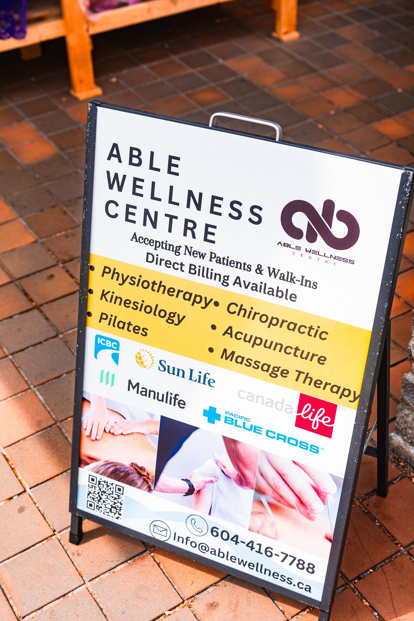 The clinic sidewalk sign listing direct billing and accepted insurers
