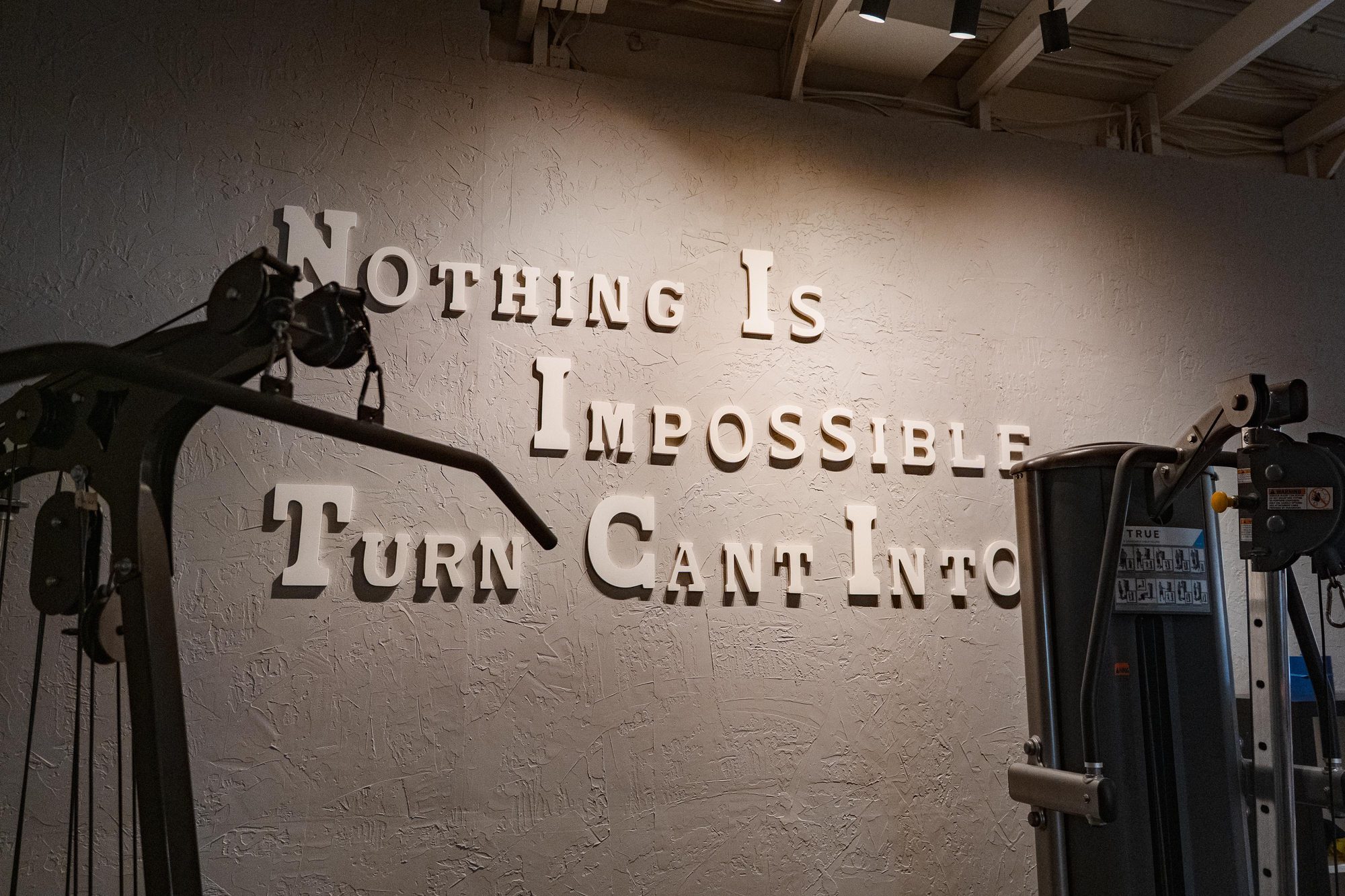 Lettering on the gym wall reading Nothing is impossible